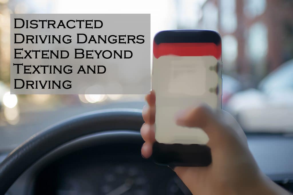 a hand holding a cell phone texting and driving - Warren, RI personal injury attorney Abilheira Law, LLC